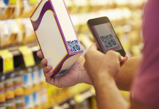 Man Scanning Voucher Code In Supermarket With Mobile Phone                        -NOTE TO EDITOR-            -PHONE SCREEN AND BARCODE-                  - CREATED FOR SHOOT-