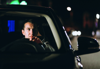 Young man driving his car at a night time