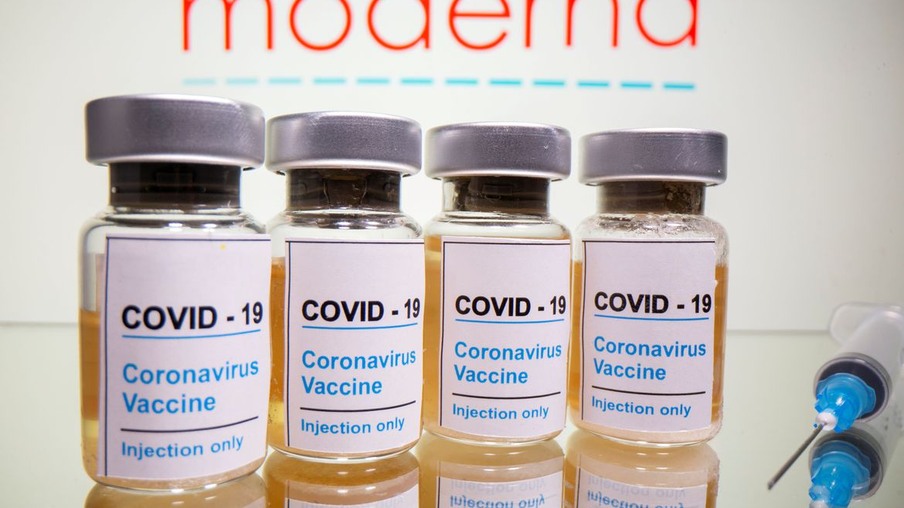 FILE PHOTO: Vials with a sticker reading, "COVID-19 / Coronavirus vaccine / Injection only" and a medical syringe are seen in front of a displayed Moderna logo in this illustration taken October 31, 2020. REUTERS/Dado Ruvic/Illustration/File Photo