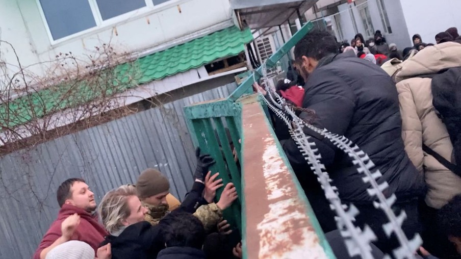 Still image from video shows people pushing at a gate as civilians and Polish Border Guard push back, after those fleeing the Russian invasion of Ukraine try to leave the country, as seen from the Shehyni-Medyka border crossing on the Ukrainian side with Poland February 26, 2022 in this handout video. Content filmed February 26, 2022. Lubomir Smatana - Czech Radio Radiozurnal/Handout via REUTERS 

THIS IMAGE HAS BEEN SUPPLIED BY A THIRD PARTY. MANDATORY CREDIT. NO RESALES. NO ARCHIVES